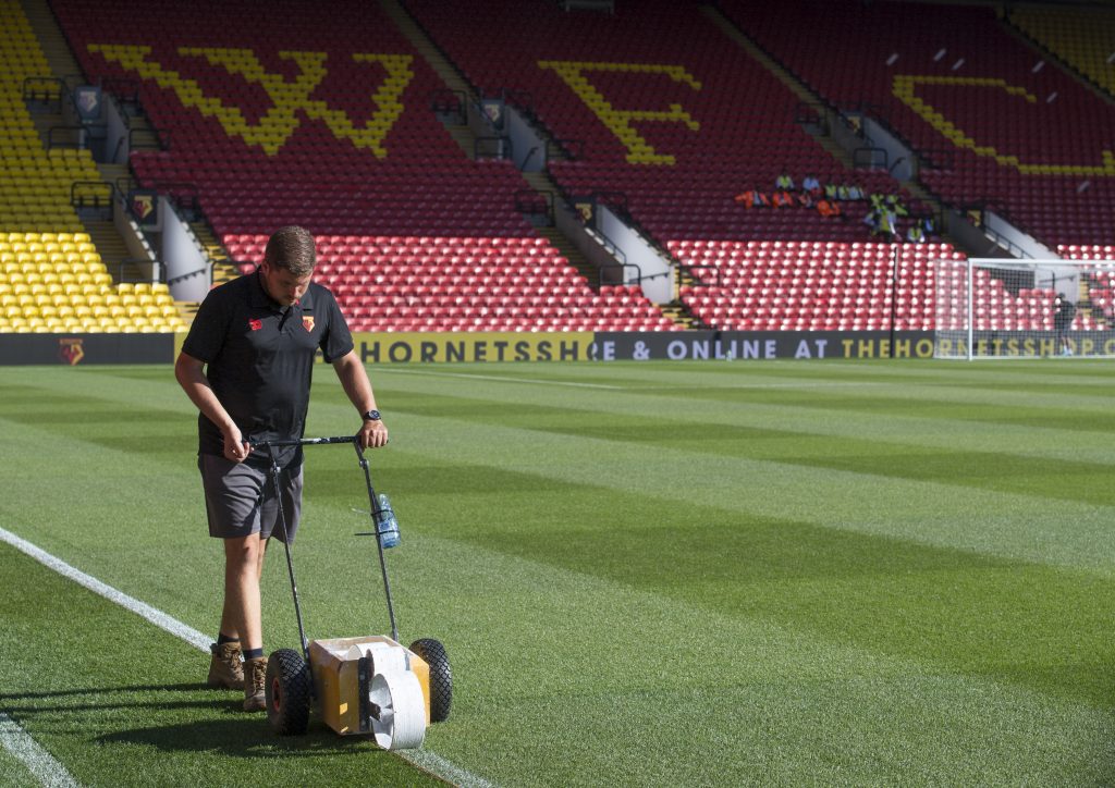 Watford FC’s Head Groundsman Scott Tingley marking out the pitch at Vicarage Road